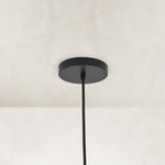 Matte-black ceiling canopy and suspension detail