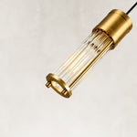 Angled detail of the brass ringed ribbed glass mini pendant