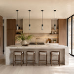 Matte-black ringed ribbed glass mini pendants over a kitchen island