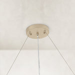 Neutral slatted ring chandelier, 31-inch canopy and cables.