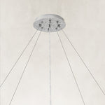 Silver-colored chandelier canopy and suspension cables.