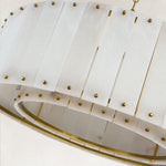 Single-tier panel chandelier, panel edge and brass-tone concentric frame.