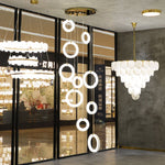A cascading ring-light installation displayed among other fixtures in a showroom.