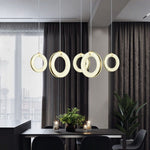 Alabaster ring lights arranged above a dining table.