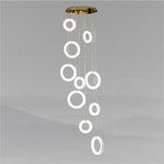 Cascading group of alabaster ring lights suspended from a ceiling canopy.