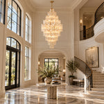 Tall tiered glass chandelier in a double-height foyer