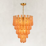 Amber textured glass cascade chandelier with Brass-finish hardware, shown as a complete fixture