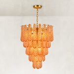 Amber textured glass cascade chandelier with Brass-finish hardware, shown as a complete fixture