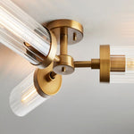 Close-up of the brass-tone central mount and radial glass cylinder arms.