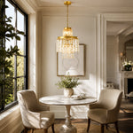 Compact crystal drum chandelier above a round dining table by tall windows.