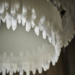 Close-up of pointed selenite pieces along the chandelier's lower edge.
