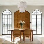 Brass-finish two-tier alabaster panel pendant above a dining table