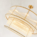 Gold-tone two-tier chandelier with vertical glass rods.