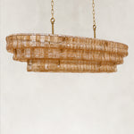 Unlit amber glass linear chandelier viewed at an angle.