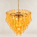 Angled view of the tiered amber chandelier and its upper frame.