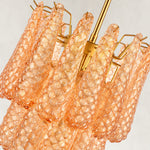 Close view of textured amber drops and gold-tone support arms.