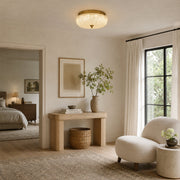 Illuminated textured glass flush mount in a furnished hallway