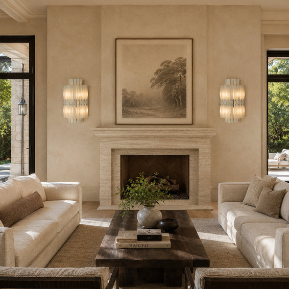Pair of vertical layered marble wall sconces lighting a furnished seating area