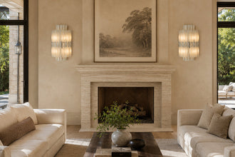 Pair of vertical layered marble wall sconces lighting a furnished seating area