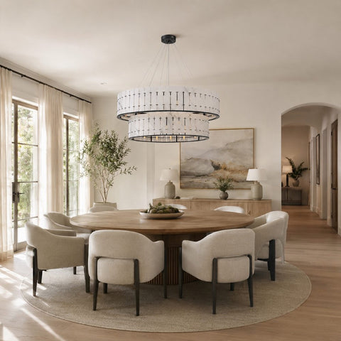 Dining room chandelier scaled above a refined table setting