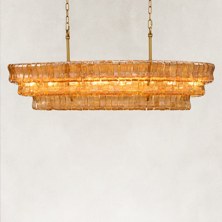 Amber fluted glass linear chandelier with stepped tiers