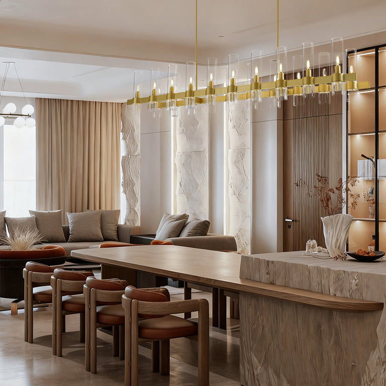 Brass-finish clear glass tube linear chandelier in a furnished room