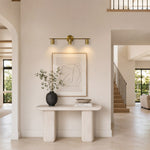 Adjustable Triple Cylinder Picture Light in Natural Brass - interior setting