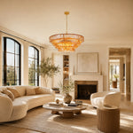 Amber round chandelier in a curved-sofa living room.