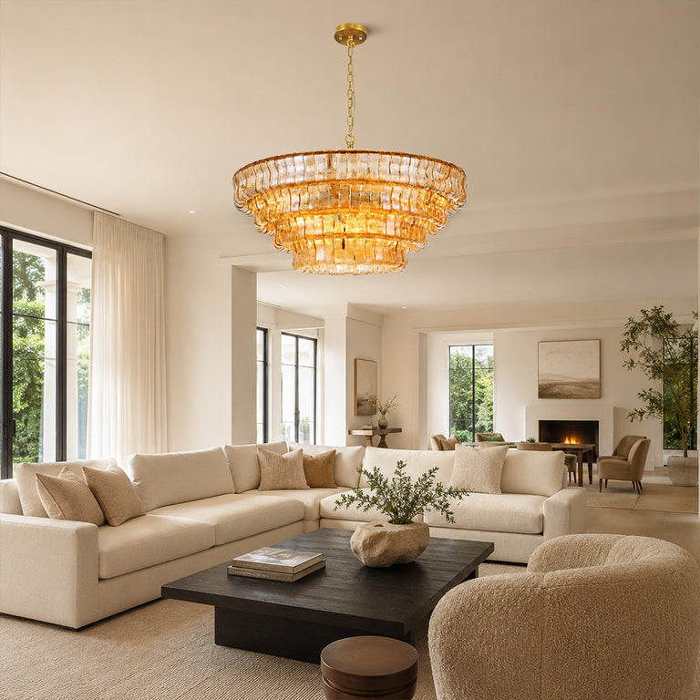 Amber round chandelier above a dark coffee table.