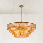 Amber fluted-glass round chandelier in an angled illuminated view.