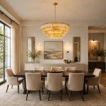 Amber round chandelier above a dining table with a sideboard.