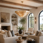 Amber tiered-glass chandelier in an arched-window living room.