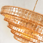 Illuminated amber fluted-glass tiers in close-up.