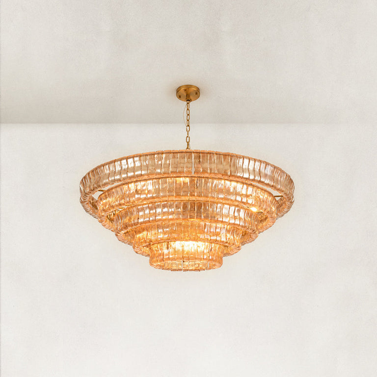 Illuminated amber glass chandelier viewed from below.