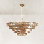 Unlit amber glass tiered round chandelier.
