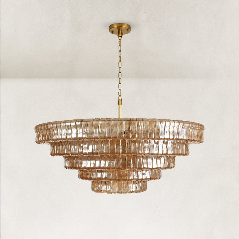 Unlit amber glass tiered round chandelier.