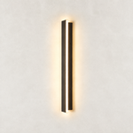 Illuminated Averon wall sconce with a narrow vertical profile