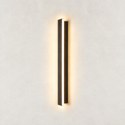 Illuminated Averon wall sconce with a narrow vertical profile