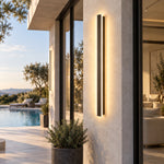 Long black wall sconce poolside entry scene