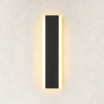 Black slim wall sconce illuminated frontal view