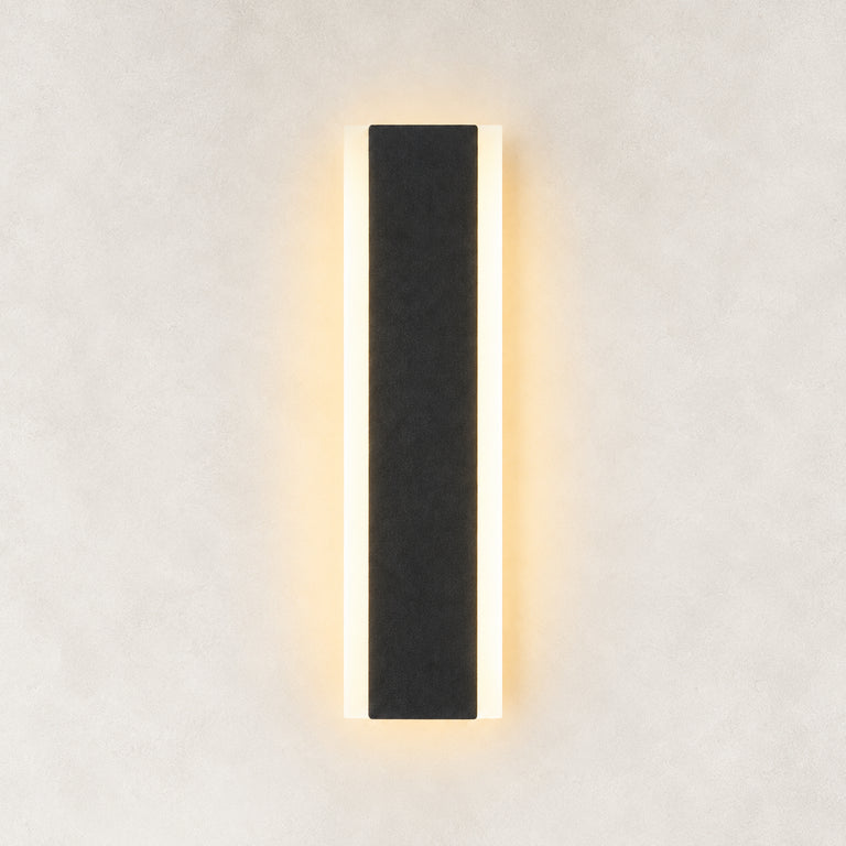Black slim wall sconce illuminated frontal view