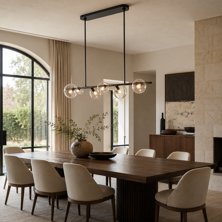 Black bubble glass chandelier above a wooden dining table in an interior setting
