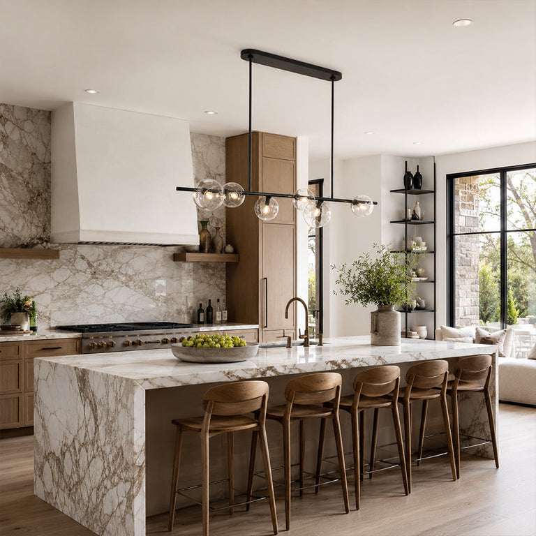 Black bubble glass linear chandelier above a kitchen island in an interior setting