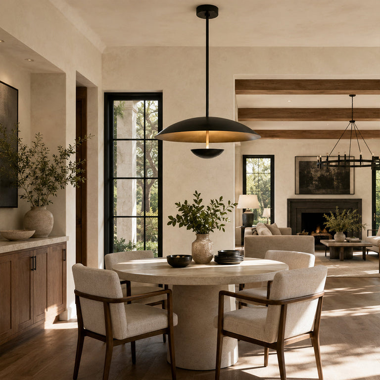 Black disc pendant above a dining table near a living room