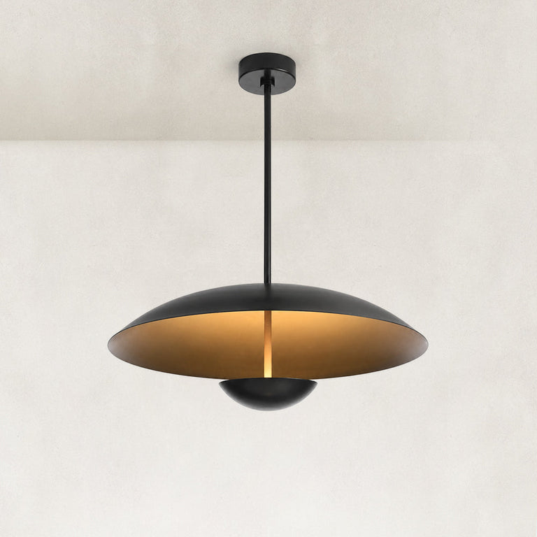 Black disc pendant illuminated against a neutral background