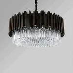 Round black fin chandelier with hanging crystal rods against a neutral background.