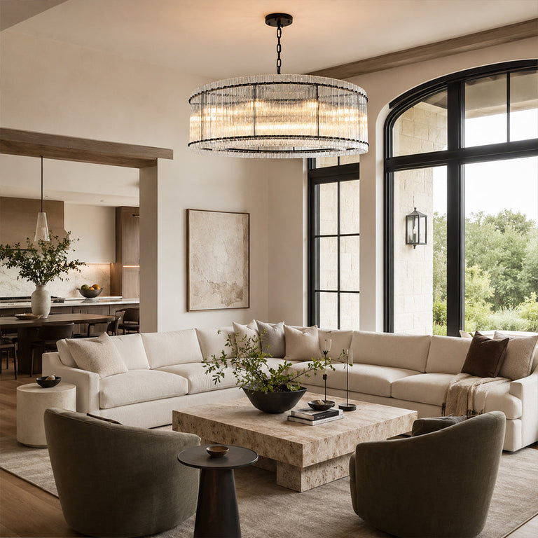 Black glass rod drum chandelier in a living room by tall arched windows