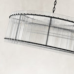 Black glass rod drum chandelier viewed from below at an angle