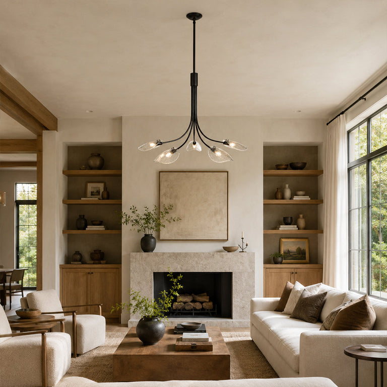 Black leaf glass chandelier above a living room seating area in an interior setting