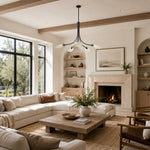 Black leaf glass chandelier in a living room with a fireplace